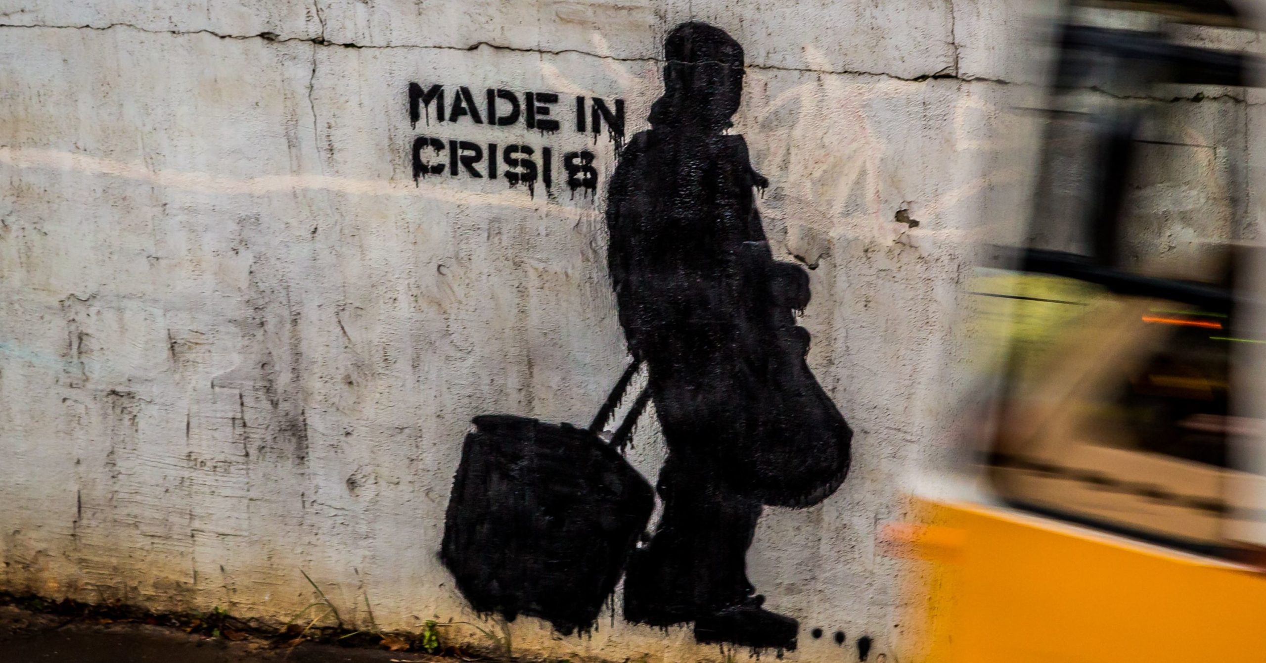 Stencilled image of a man against a wall with a caption that says "made in crisis"